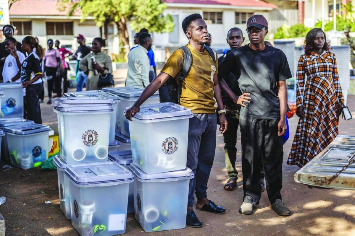 Young electoral officials prepare ballot boxes for dispatch at a polling station serving as a dispatch centre during final preparations ahead of Uganda’s 2026 general elections, in Kampala on January 14, 2026. (AFP)