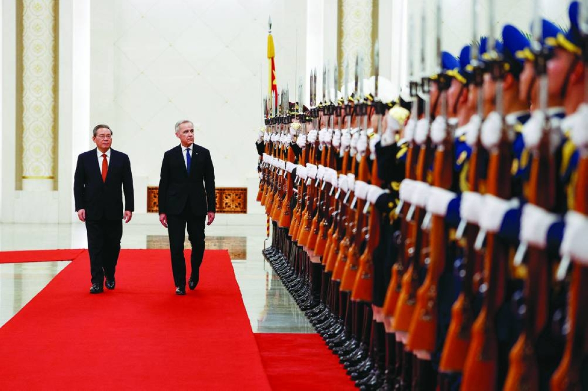 Canada's Prime Minister Mark Carney and China's Premier Li Qiang review the honour guard at an official welcoming ceremony, during the first visit by a Canadian prime minister to China since 2017, at the Great Hall of the People in Beijing, China, Thursday.