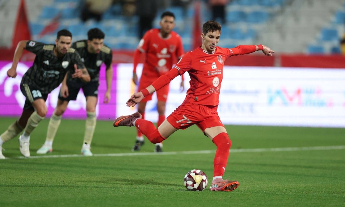 Al Duhail's Adil Boulbina scores from the penalty spot against Al Wakrah.
