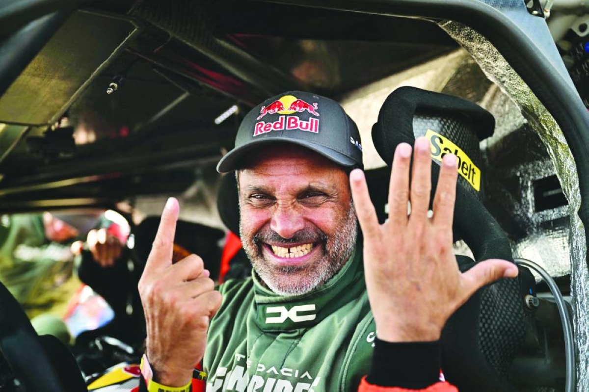 Nasser al-Attiyah gestures with his hands to indicate his sixth Dakar Rally victory.