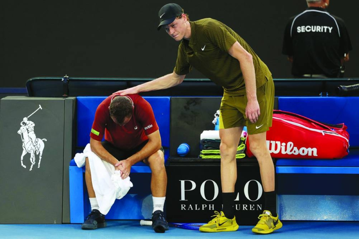 Italy’s Jannik Sinner (right) consoles France’s Hugo Gaston as Gaston retires injured from their Australian Open match in Melbourne Tuesday. (AFP)