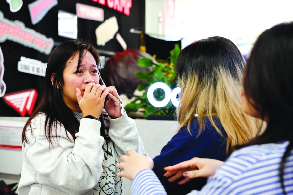 Joanna from Philippines, a fan of K-pop band BTS, reacts as she receives a call that her friend also got tickets for BTS’s first South Korea concert in years, as part of their world tour, at a PC cafe in Seoul, South Korea, Thursday.