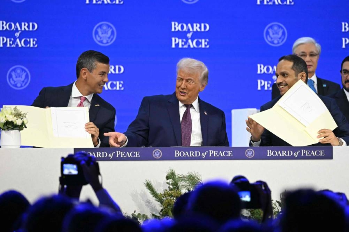 Paraguay's President Santiago Pena (L) and Qatar's Prime Minister Sheikh Mohammed bin Abdulrahman bin Jassim al-Thani hold a signed founding charter next to US President Donald Trump (C) at the "Board of Peace" meeting during the World Economic Forum (WEF) annual meeting in Davos on January 22, 2026. US President Donald Trump will show off his new "Board of Peace" at Davos on January 22, 2026, burnishing his claim to be a peacemaker a day after backing off his own threats against Greenland. Originally meant to oversee the rebuilding of Gaza after the war between Hamas and Israel, the board's charter does not limit its role to the Strip and has sparked concerns that Trump wants it to rival the United Nations. (AFP)
