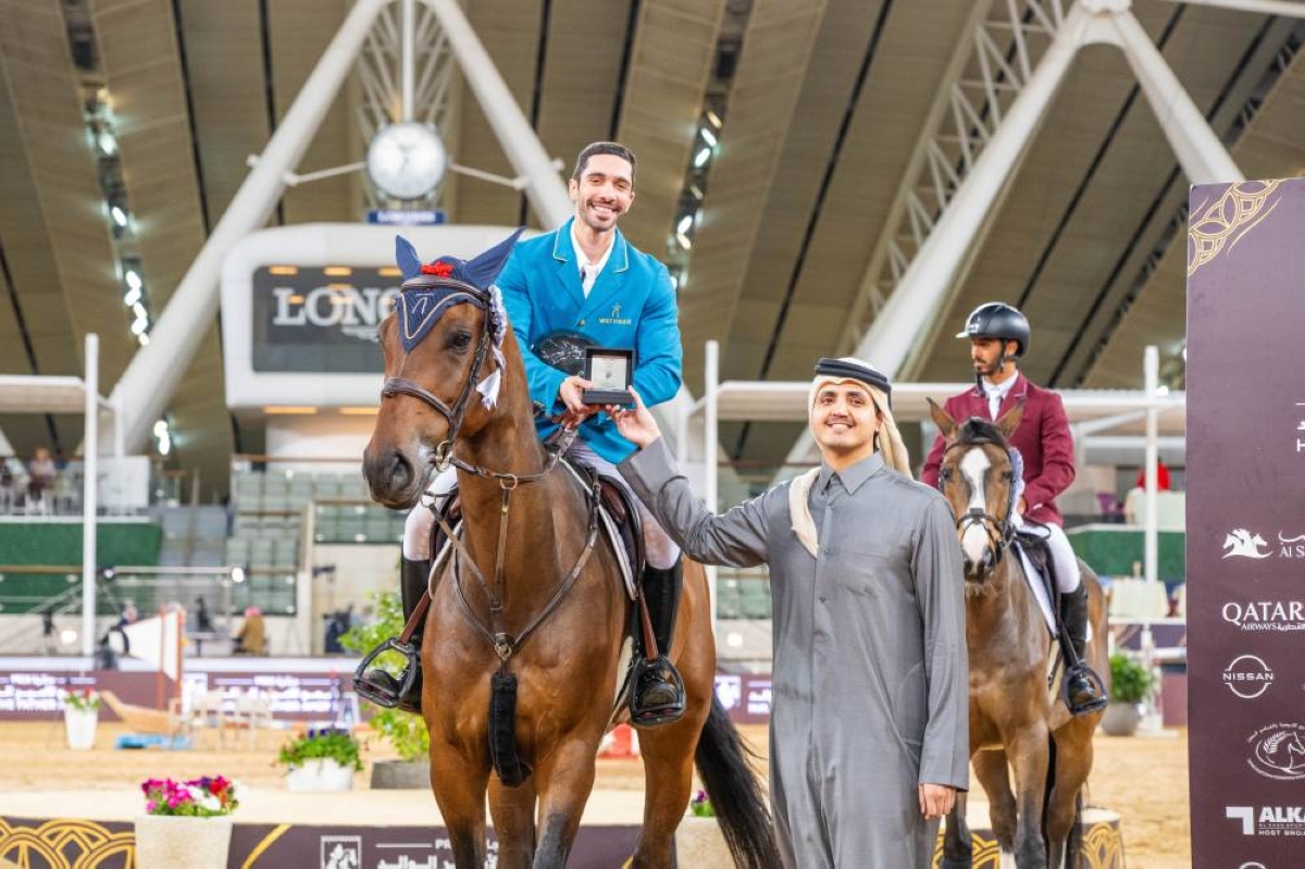 His Excellency Sheikh Thani bin Hamad bin Khalifa al-Thani, Chairman of the Board of Directors of the Qatar Fund for Development, presents the trophy to Salman Mohammed al-Emadi, who finished second in the CSI5* Two Phases 1.40m class at the third round of the HH The Father Amir's Prix at Al Shaqab.