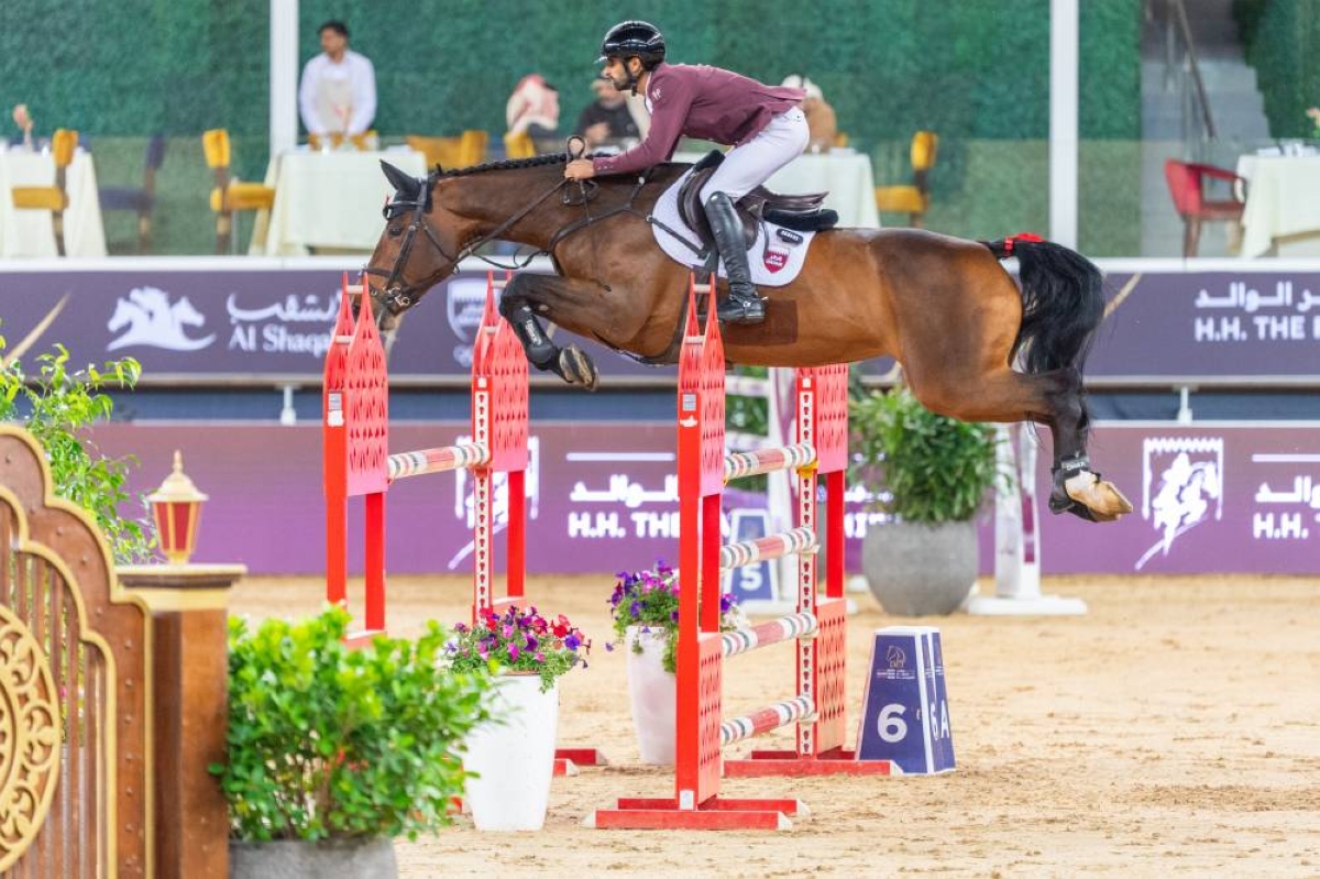 Qatar's rider Rashid Towaim al-Marri in action aboard Navaronne clears a rail.