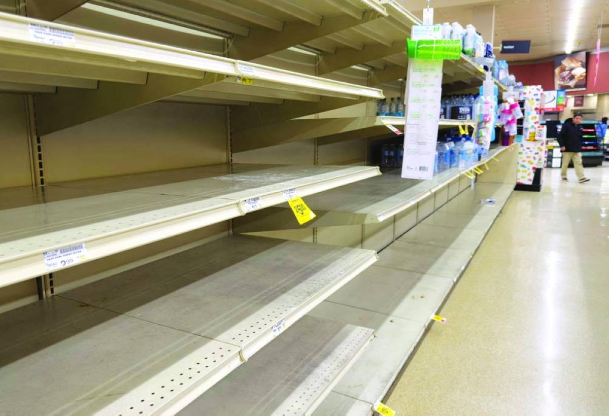 Empty shelves are seen as residents stock up on supplies ahead of a cold front expected in the area in Arlington, Virginia. – AFP