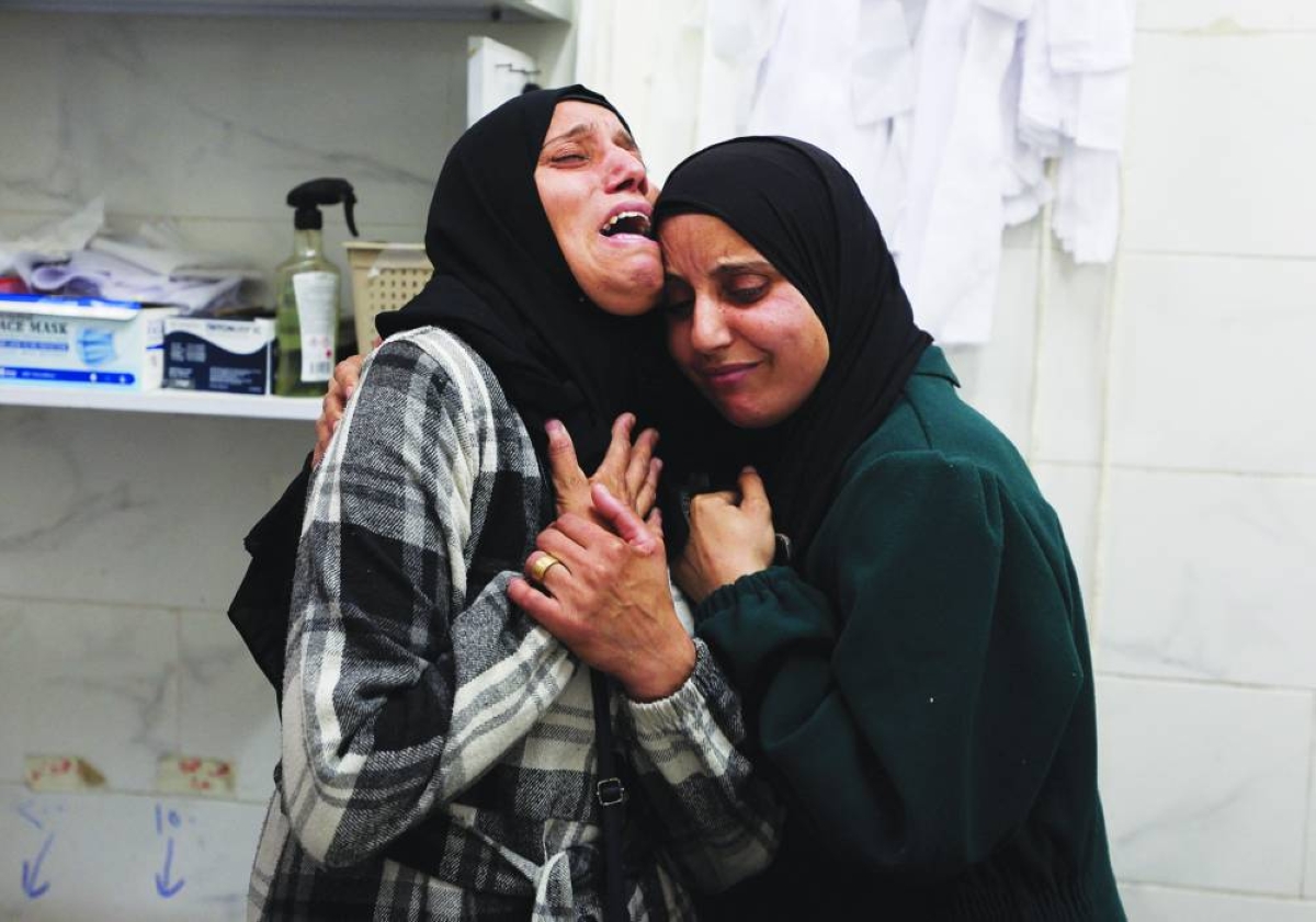 Mourners react during the funeral of Palestinians who, according to medics, were killed by Israeli strikes Saturday, at Al-Shifa Hospital in Gaza, Saturday.