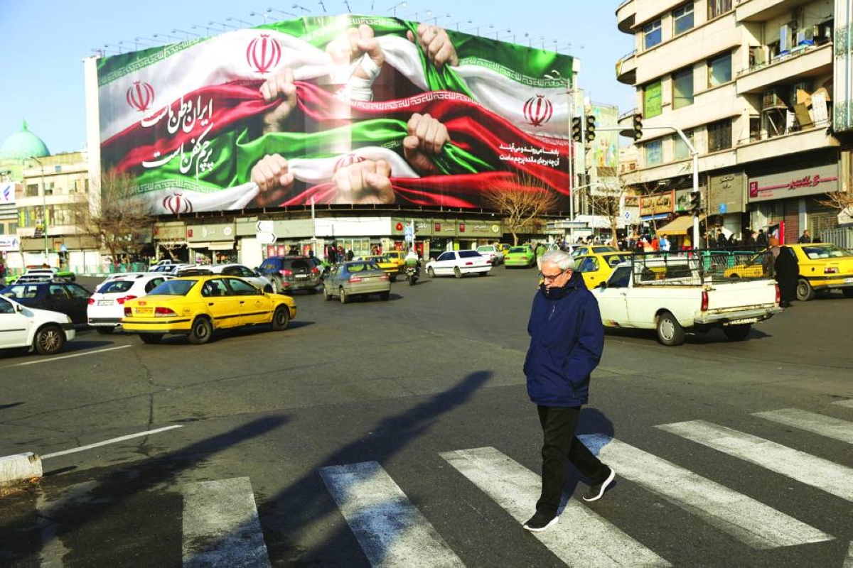 A man walks on a street in Tehran, Iran, Saturday.