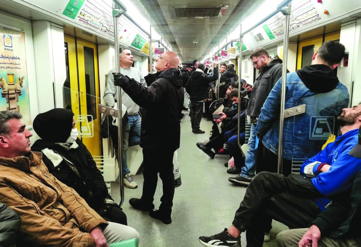 Commuters travel on a metro train in the capital Tehran, Saturday.