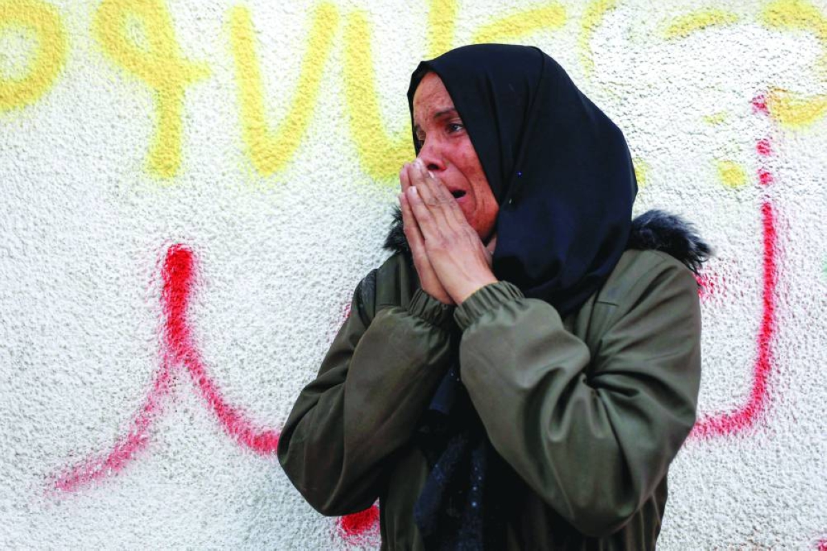 A woman reacts outside a morgue where forensic experts examine the bodies of Palestinians returned by Israel the previous day, as part of the Gaza ceasefire deal, at Al-Shifa hospital in Gaza City, yesterday.