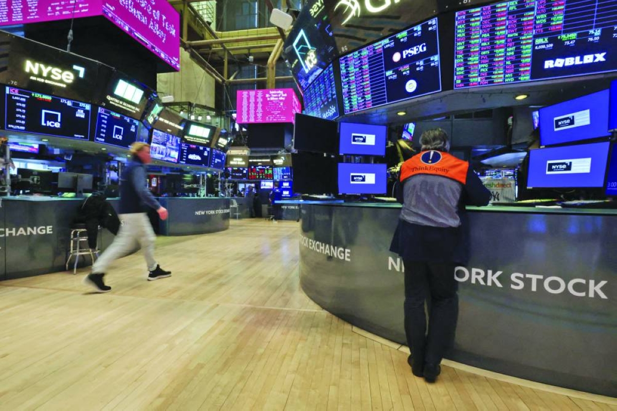 Traders work on the floor at the New York Stock Exchange. Another huge batch of corporate earnings including from megacaps Alphabet and Amazon will test the US stock market in the coming ‌week after a disappointing report from heavyweight Microsoft weighed on equity indexes.