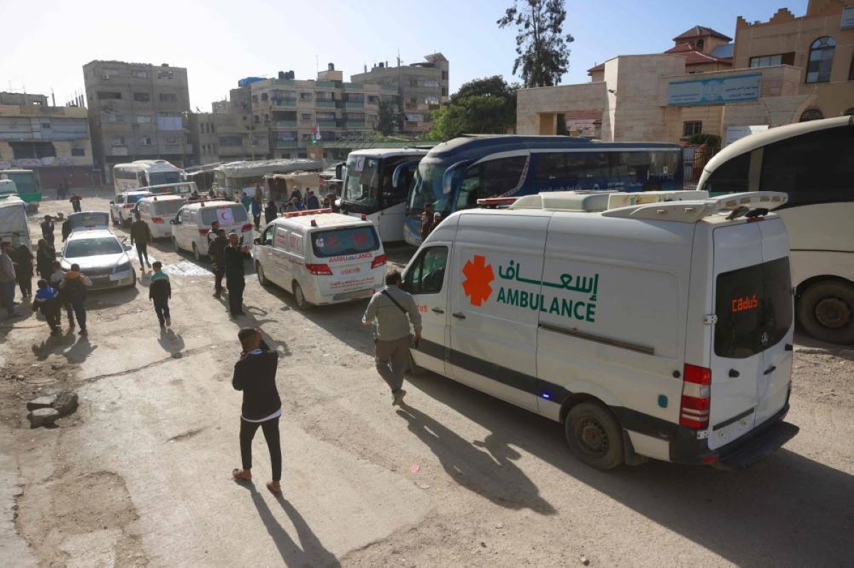 Ambulances carrying Palestinians patients and war-wounded people, accompanied by relatives, get ready to leave the Gaza Strip for their treatment abroad through the Rafah border crossing between Gaza and Egypt, days after it was opened by Israel for a limited number of people, in Khan Yunis, in the southern Gaza Strip on February 3, 2026. Dozens of injured Palestinians and their companions entered Egypt from Gaza on January 1, the first day of a limited reopening of the Rafah border crossing, a source on the Egyptian side of the border told AFP. The reopening, demanded by the United Nations and aid groups, is a key part of the second phase of US President Donald Trump's truce plan for Gaza, where humanitarian conditions remain dire after two years of war. (Photo by Bashar Taleb / AFP)