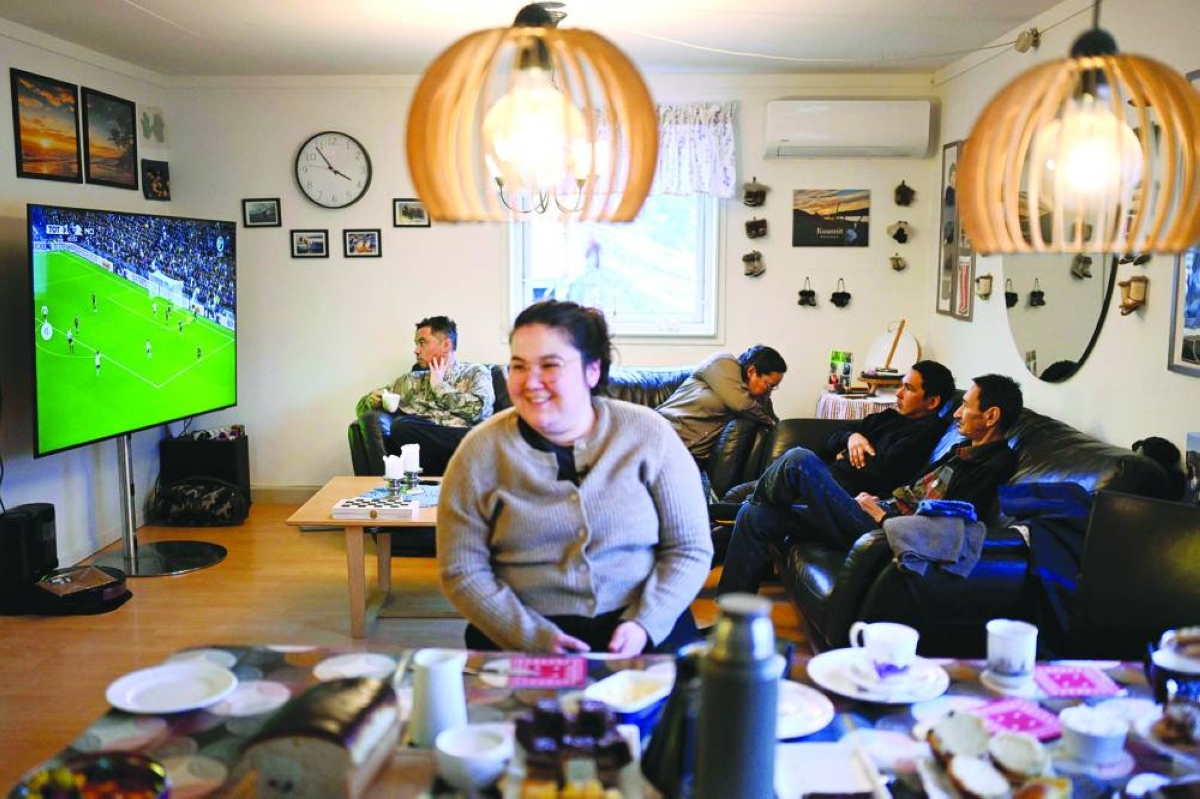 
The family of teacher Dorthe Olsen watches football at their home at the settlement Sarfannguit, near Sisimiut, Greenland. 