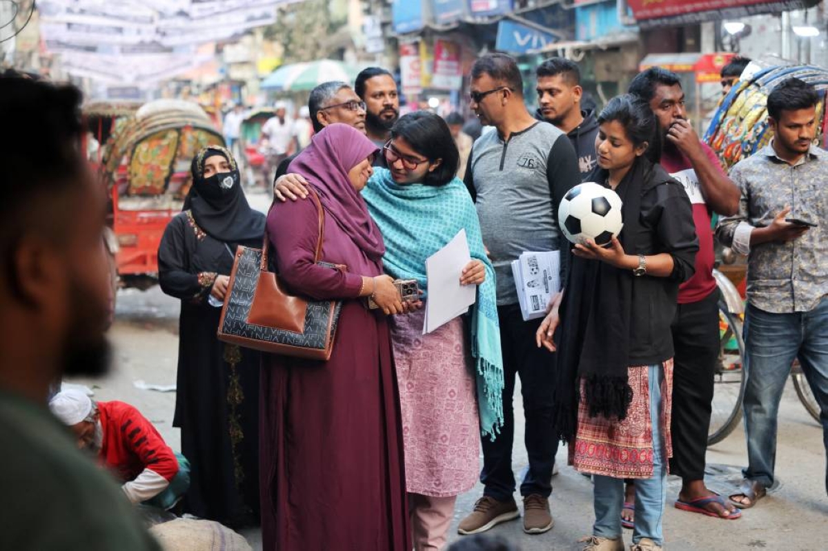 Tasnim Jara, an independent candidate for Dhaka-9 constituency, interacts with voters during an election campaign ahead of the national election in Dhaka.