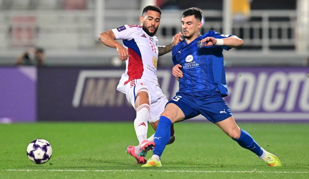 Al Duhail's Bassam al-Rawi (right) and Sharjah's Luanzinho vie for the ball.