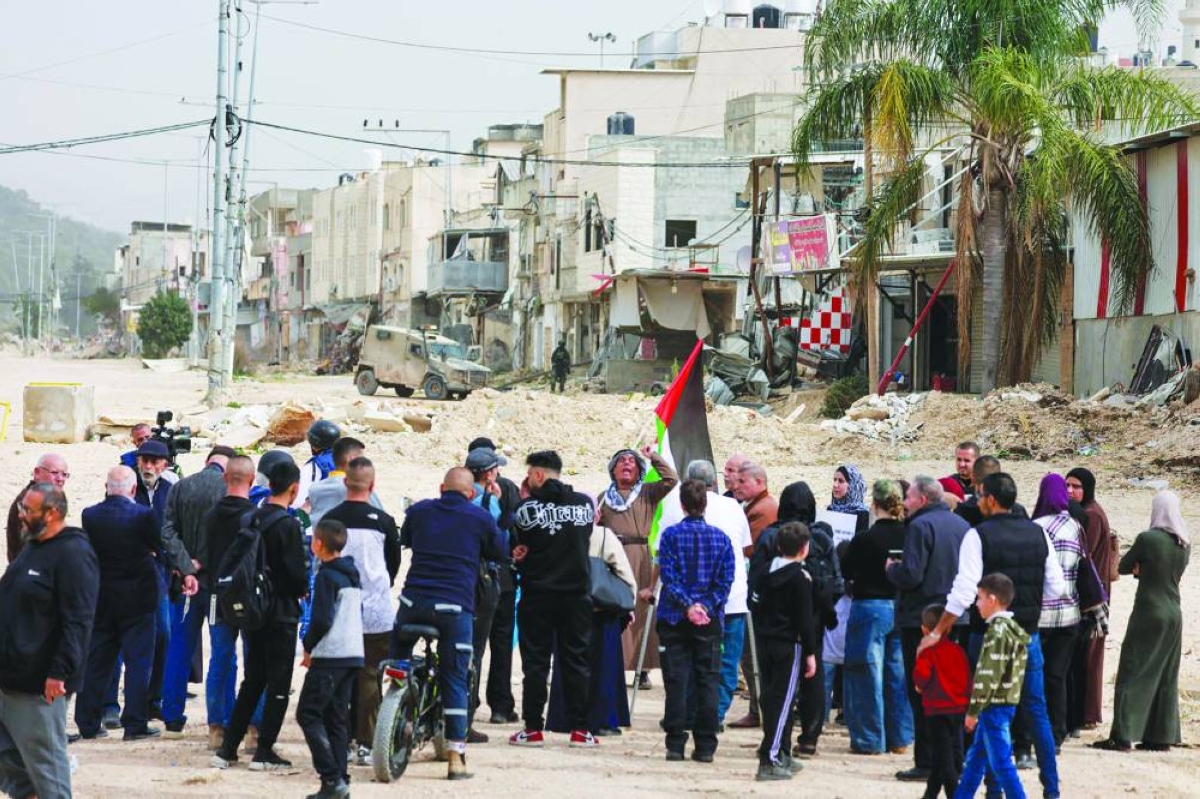 Palestinians protest after Israeli soldiers blocked the entrance of the Nur Shams Palestinian refugee camp in the occupied West Bank on February 9, 2026, demanding to be allowed to return to their homes from where they were expelled last year during an ongoing Israeli army operation. Saudi Arabia and seven other Muslim-majority countries on February 9 condemned new Israeli measures to tighten control of the West Bank and pave the way for more settlements in the occupied Palestinian territory. (AFP)