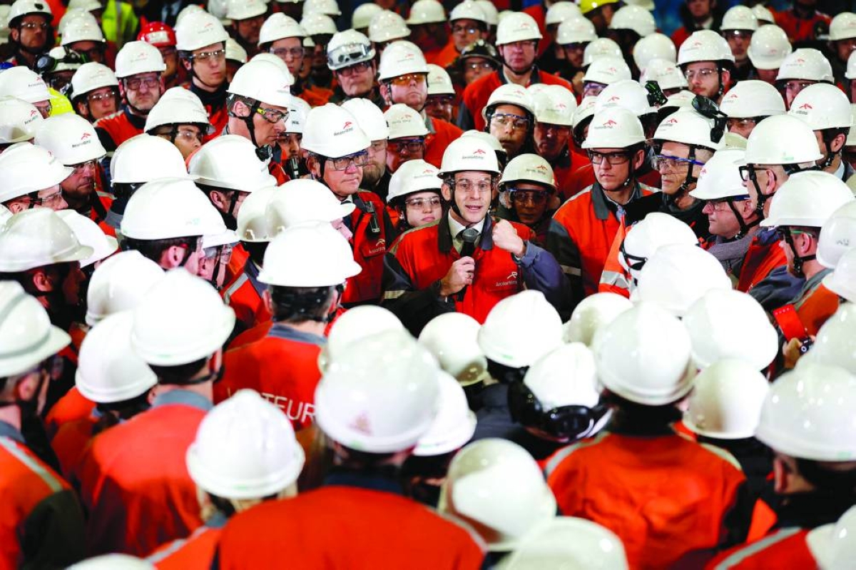 French President Emmanuel Macron gestures as he delivers a speech surrounded by employees during his visit to the Mardyck Electryck site dedicated to the electric steel production at one of steelmaker ArcelorMittal’s plants in Dunkirk, northern France. Reuters