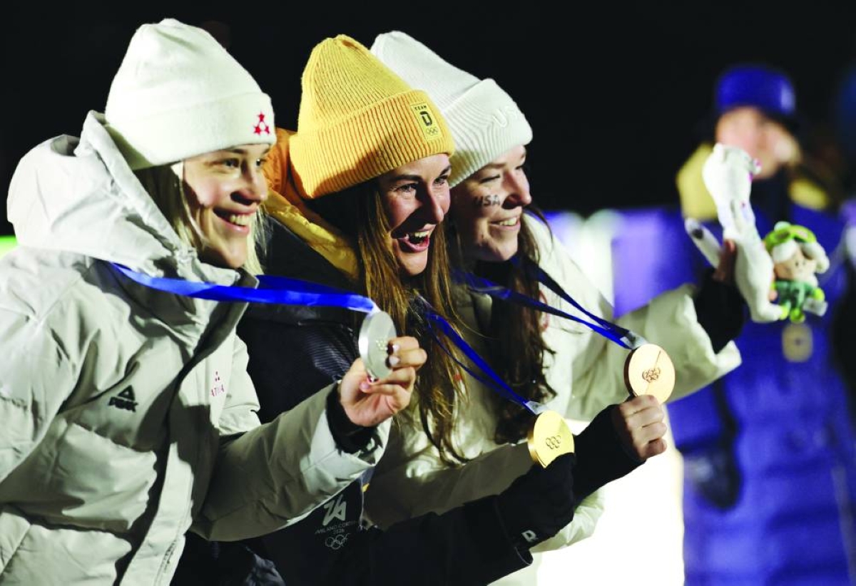 Milano Cortina 2026 Olympics - Luge - Women's Singles Victory Ceremony - Cortina Sliding Centre, Cortina d'Ampezzo, Italy - February 10, 2026.
Gold medallist Julia Taubitz of Germany celebrates on the podium during the women's singles victory ceremony with silver medallist Elina Bota of Latvia and bronze medallist Ashley Farquharson of United States REUTERS