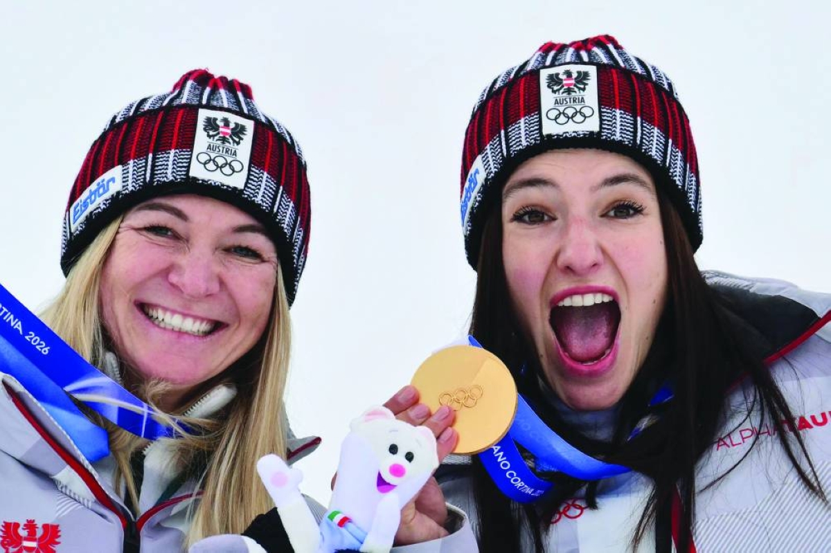 Gold medallists Austria's Ariane Raedler (left) and Austria's Katharina Huber pose on the podium of the women's team combined event during the Milano Cortina 2026 Winter Olympic Games at the Tofane Alpine Skiing Centre in Cortina d’Ampezzo Tuesday. (AFP)