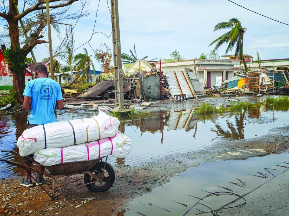 A resident leans on a cart near destroyed structures in the city of Toamasina, on the east coast of Madagascar, struck by Tropical Cyclone Gezani.