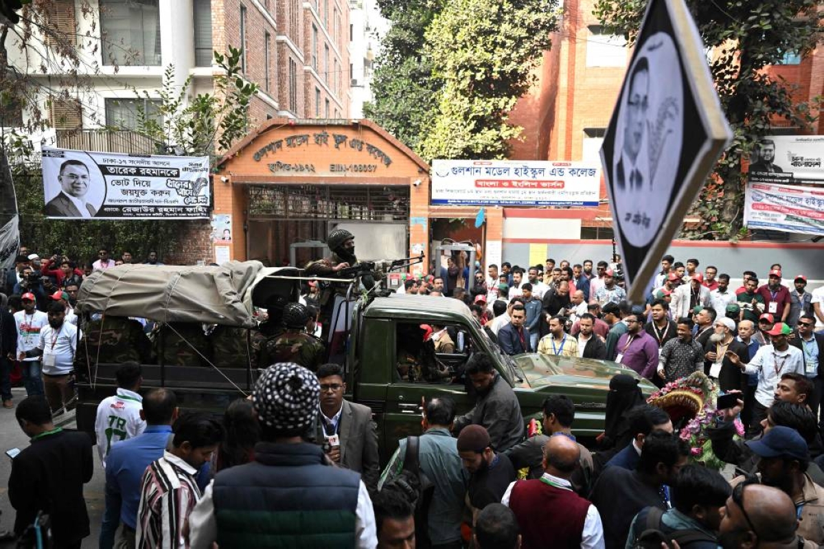 Bangladesh Army personnel patrol outside a polling station during Bangladesh's general election in Dhaka on February 12, 2026. (Photo by MUNIR UZ ZAMAN / AFP)