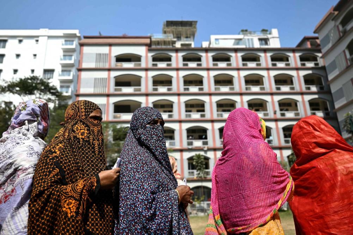 Women wait to cast their ballot at a polling station during Bangladesh's general election in Dhaka on February 12, 2026. (Photo by Sajjad HUSSAIN / AFP)