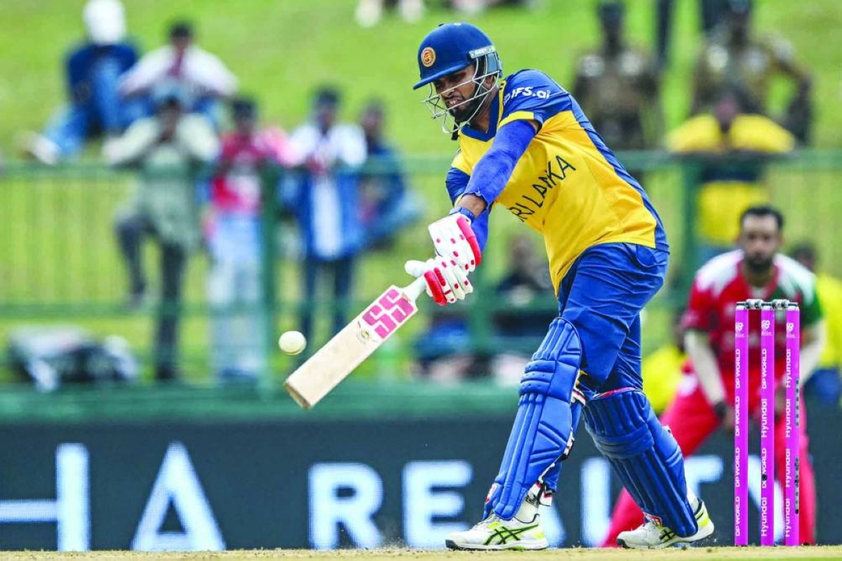 Sri Lanka's captain Dasun Shanaka plays a shot during the World Cup group stage match against Oman at the Pallekele International Cricket Stadium in Kandy Thursday. (AFP)