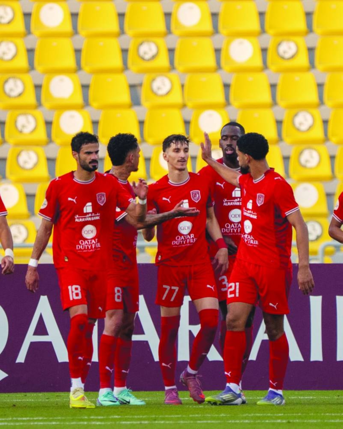 Al Duhail's Adel Boulbina (centre) celebrates with teammates.