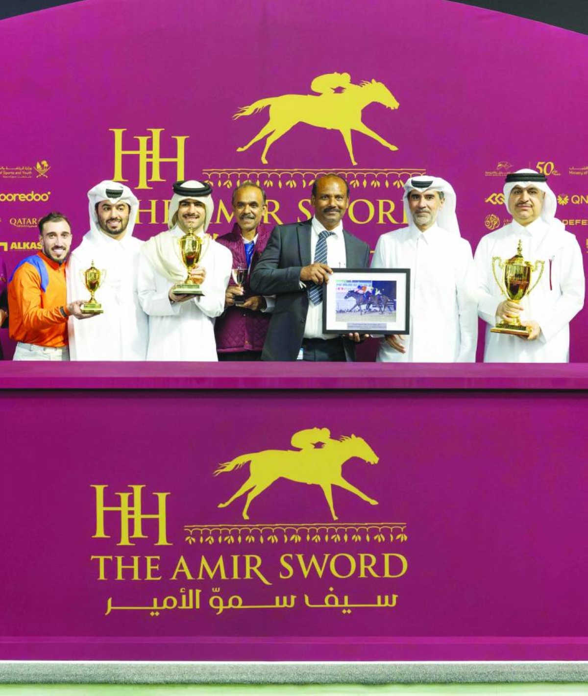 Connections of Dubawi Spectre celebrate after the six-year-old bay gelding's victory in the Thoroughbred Sand Championship Cup.