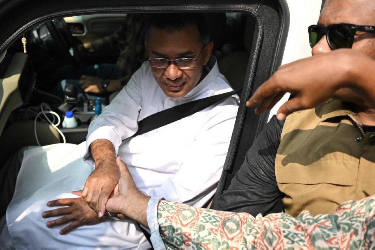 Bangladesh Nationalist Party (BNP) chairman and election candidate Tarique Rahman (L) greets his supporters as leaves his residence in Dhaka on February 13, 2026 a day after Bangladesh's general election. The Bangladesh Nationalist Party (BNP) claimed a thumping win on February 13 in the first elections held since a deadly 2024 uprising, with leader Tarique Rahman poised to become prime minister. (Photo by MUNIR UZ ZAMAN / AFP)