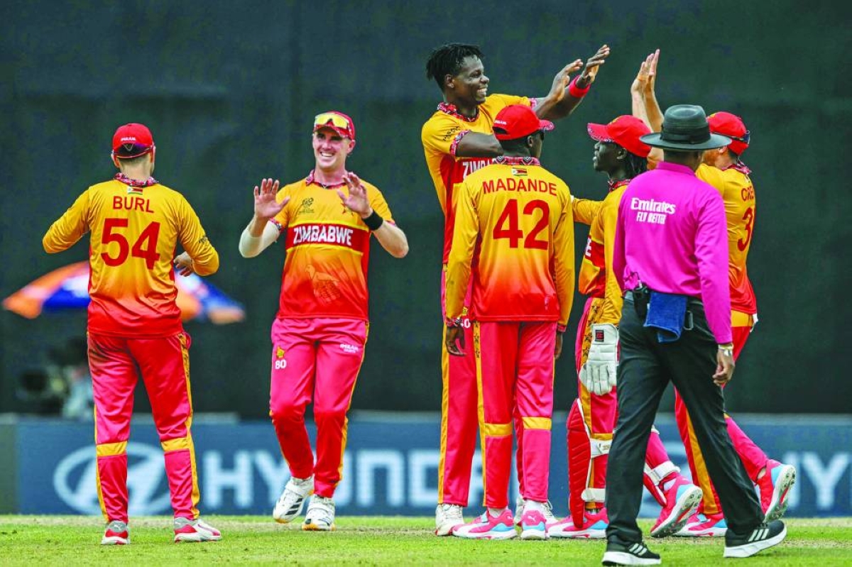 Zimbabwe's Blessing Muzarabani (C) celebrates with teammates after taking the wicket of Australia's Matt Renshaw during the 2026 ICC Men's T20 Cricket World Cup group stage match between Australia and Zimbabwe at the R Premadasa Stadium in Colombo on February 13, 2026. (Photo by Ishara S. KODIKARA / AFP)