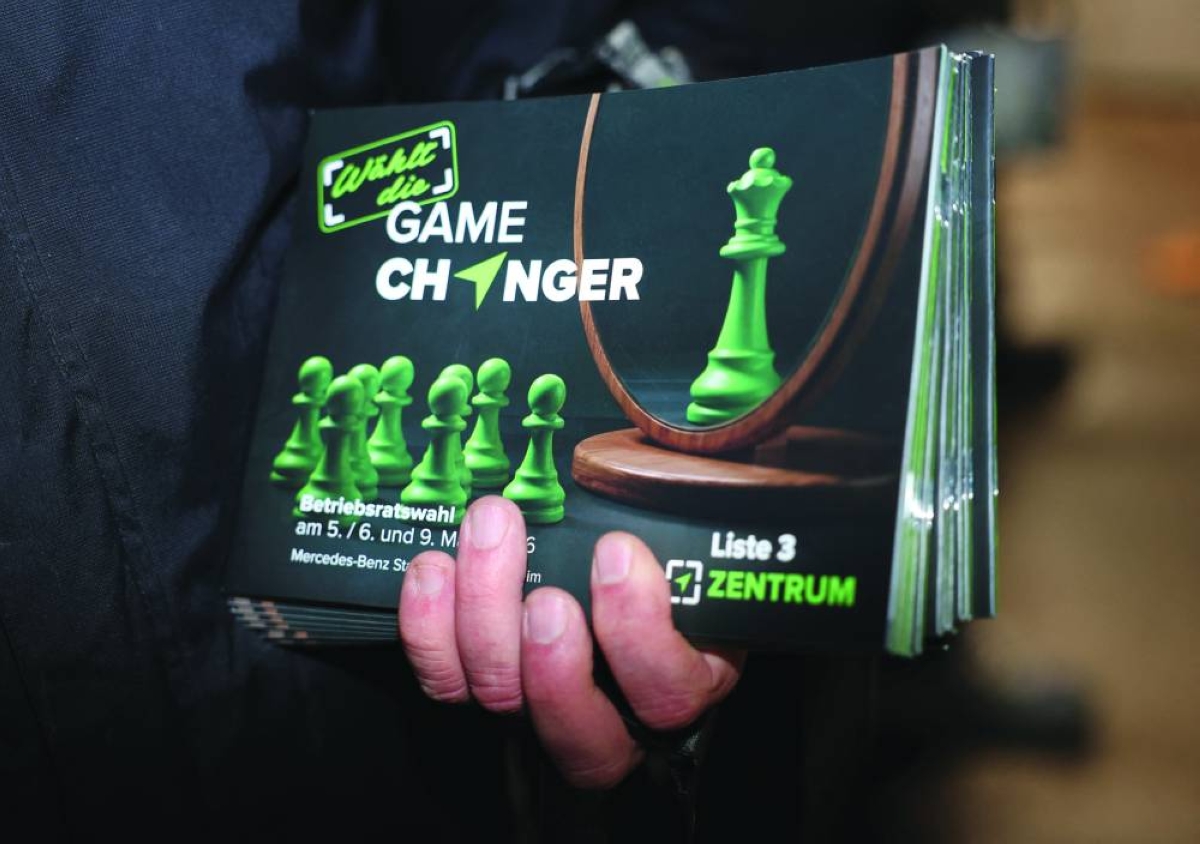 Oliver Hilburger, 56, who founded the self-styled union Zentrum in 2009, affiliated with Germany’s far-right Alternative for Germany party AFD, and himself works at the Mercedes plant in Stuttgart’s suburb of  Untertuerkheim hands out "Game-changer" flyers aiming to challenge mainstream unions "who have failed to shield the automotive sector from thousands of job cuts”, before the early morning shift at Mercedes car plant in Stuttgart, Germany, February 11, 2026.   REUTERS/Robin Rudel