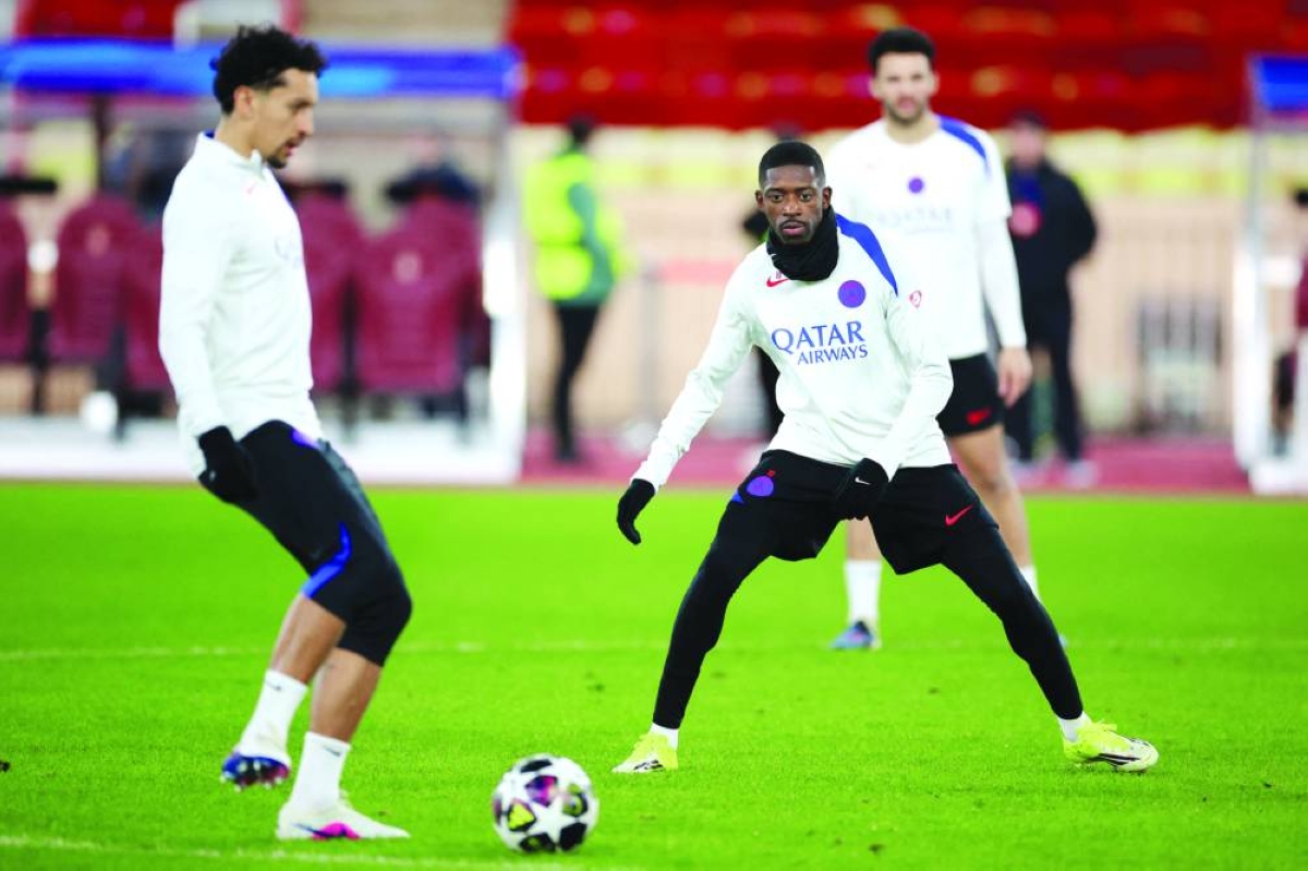 Paris Saint-Germain's Brazilian defender #05 Marquinhos (L) and Paris Saint-Germain's French forward #10 Ousmane Dembele (C) take part in a training session on the eve of Paris Saint-Germain's Champions League KO play-offs first leg football match against AS Monaco, in Monaco on February 16, 2026. (AFP)