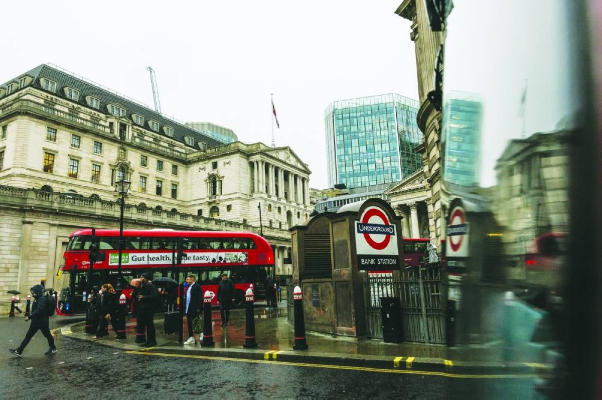 Commuters pass the Bank of England in the City of London. The BoE will watch a slew of data closely in the coming days after a knife-edge decision to keep interest rates steady on concerns that inflation is still uncomfortably high.