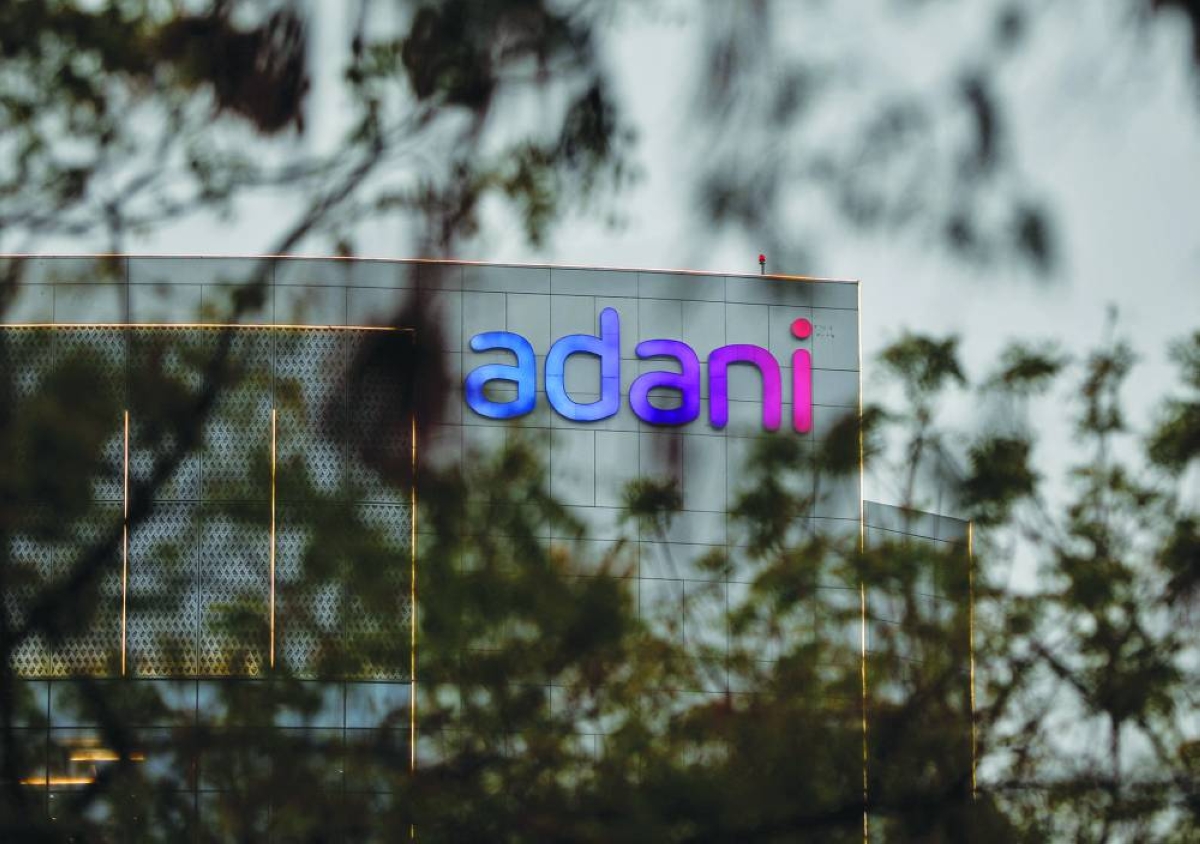 The logo of the Adani Group is seen on the facade of its Corporate House on the outskirts of Ahmedabad, India. The group plans to invest $100bn by 2035 to develop green-powered, AI-ready data centers as billionaire Gautam Adani seeks to capitalize on India’s bid to emerge as a hub for artificial intelligence and cloud computing.