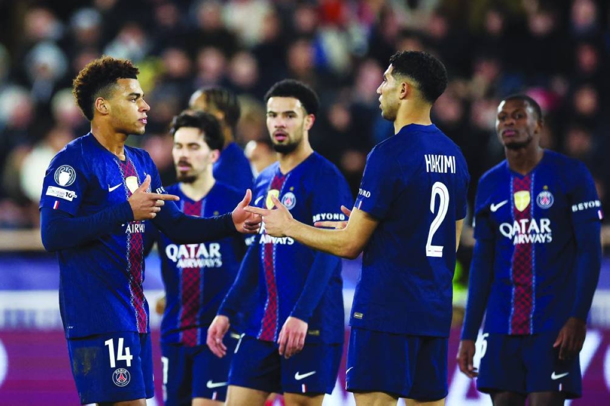 Paris Saint-Germain's Desire Doue (left) celebrates with teammates scoring his team's third goal during the UEFA Champions League knockout round play-off first leg match against Monaco at the Stade Louis II in the Principality of Monaco. (AFP)