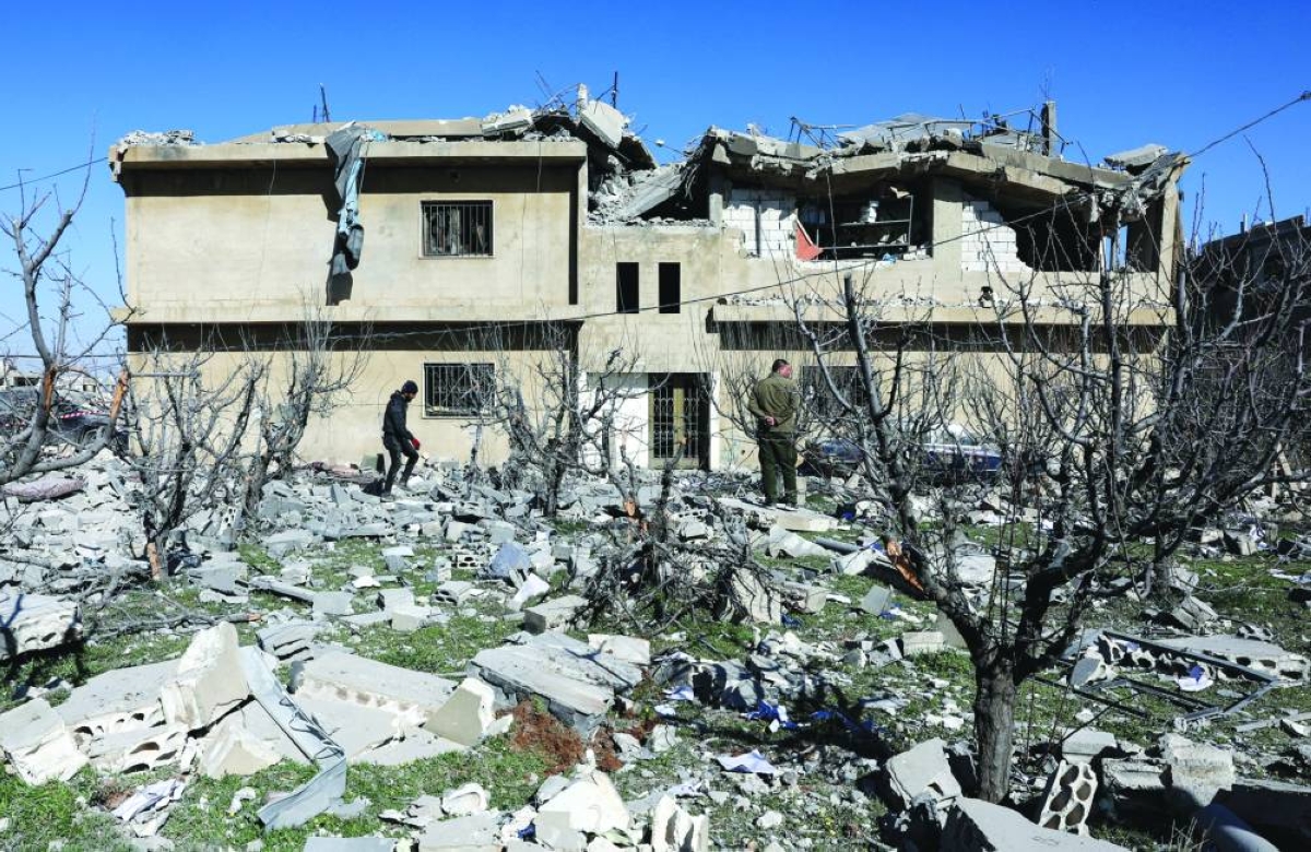 People inspect the damage at the site of an Israeli strike on Friday, in Tamnine el Tahta, Bekaa valley, Lebanon, Saturday.