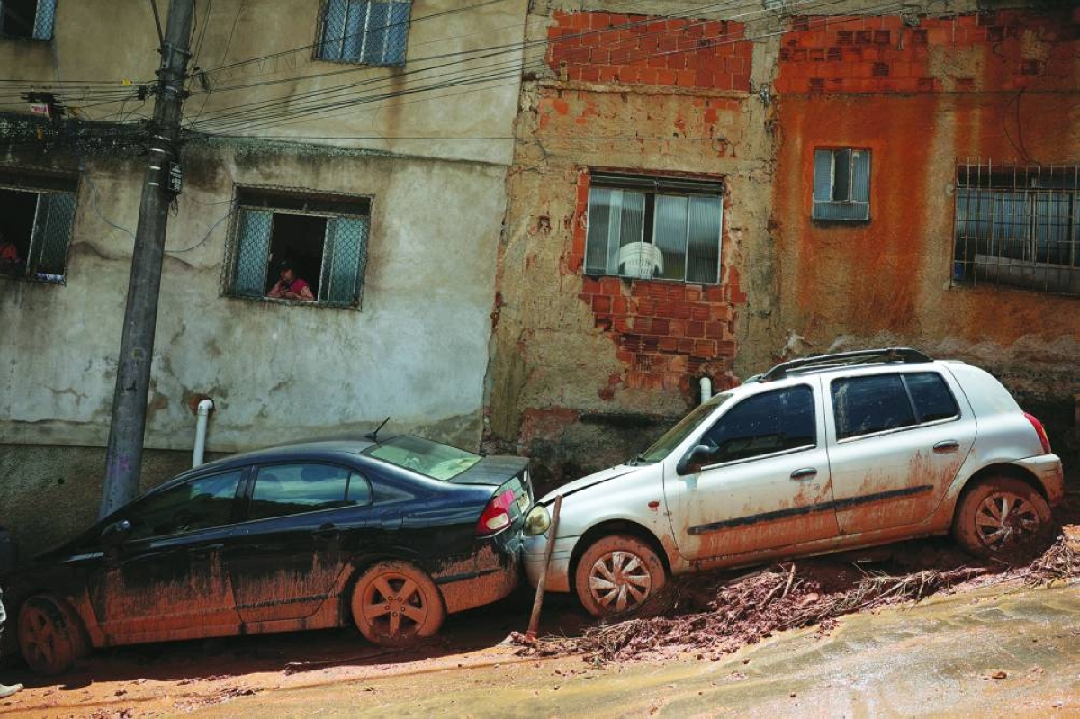 Cars and houses damaged by heavy rains in the Tres Moinhos neighbourhood, following heavy rains that killed residents and left missing people, in Juiz de Fora, Minas Gerais state, Brazil, Wednesday.