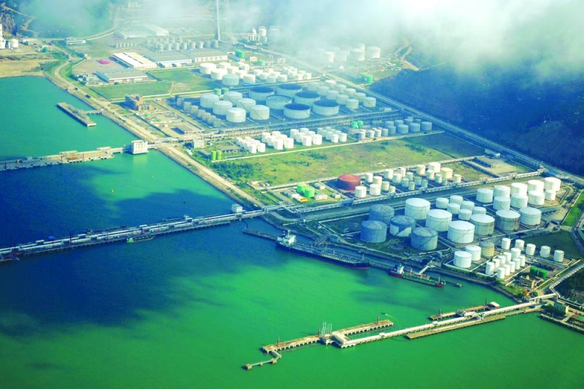 Oil and gas tanks are seen at an oil warehouse at a port in Zhuhai, China. With China unable to fully soak up the displaced crude, unsold oil is piling up in Asian waters and Russia and Iran are running out of options.