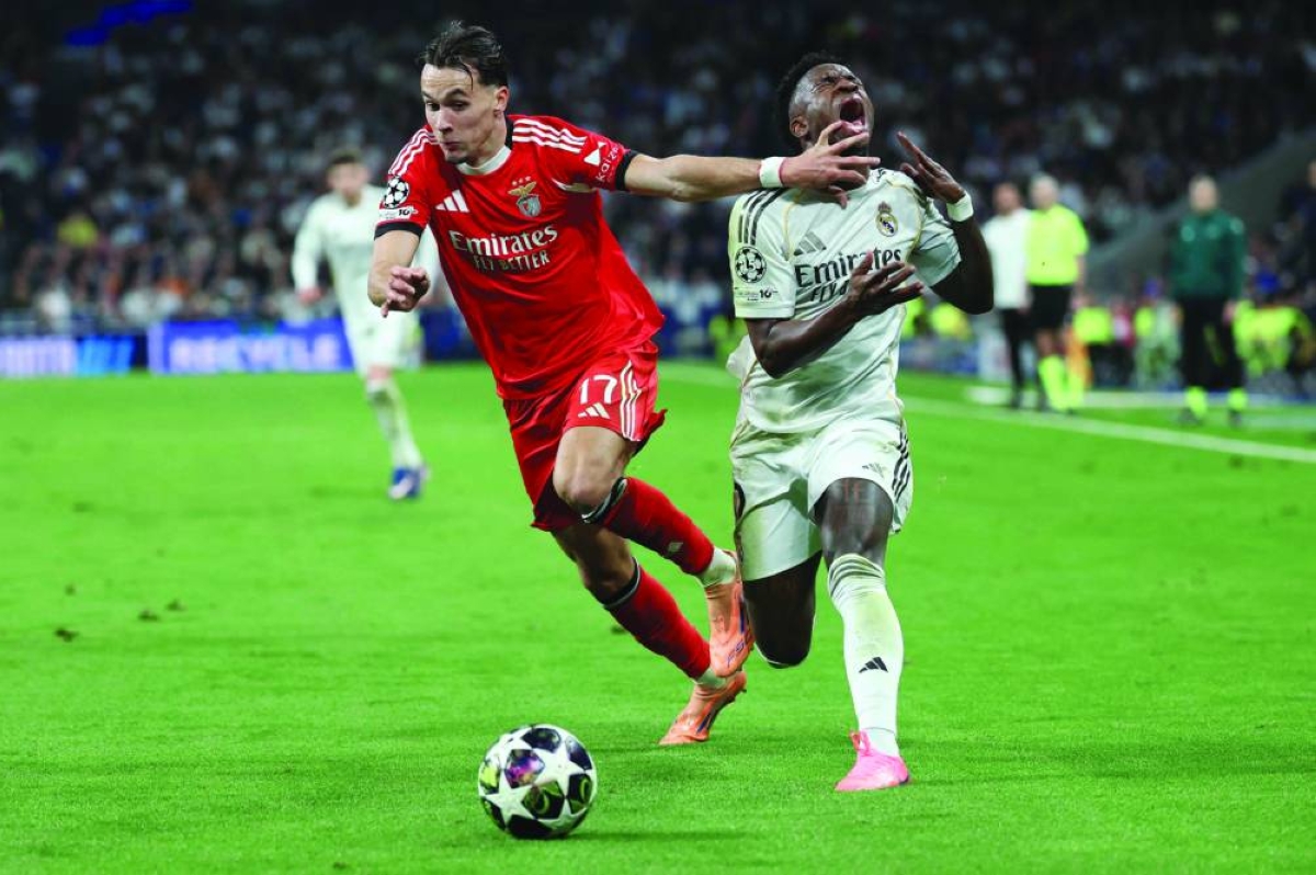 
Benfica’s Amar Dedic (left) and Vinicius Junior vie for the ball during the UEFA Champions League play-off second leg match at Santiago Bernabeu Stadium in Madrid. (AFP) 