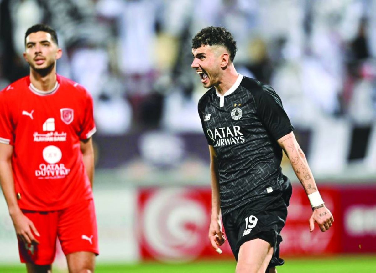 
Al Sadd’s Roberto Firmino (left) and Al Duhail’s Almoez Ali vie for the ball during the Qatar Stars League match at Abdullah Bin Khalifa Stadium. PICTURES: Noushad Thekkayil Al Sadd’s Rafa Mujica (right) celebrates after scoring against Al Duhail. 