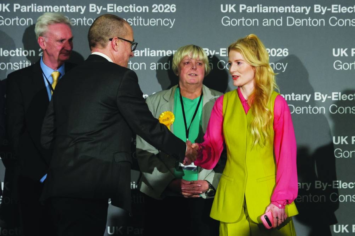 Manchester City Council's Chief Executive Tom Stannard congratulates Green Party's candidate Hannah Spencer following her victory in the Gorton and Denton by-election, at the Manchester Central Convention Complex in Manchester, Britain, yesterday.