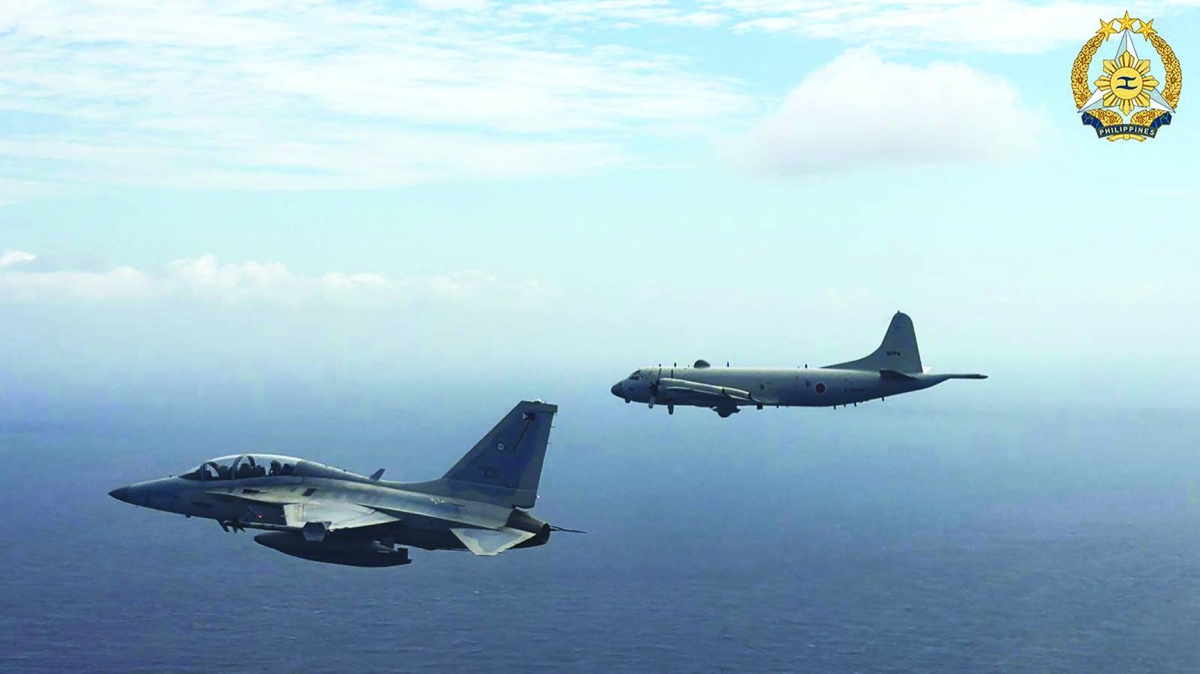 This handout photo taken on February 26, 2026 and released yesterday by the Armed Forces of the Philippines-Public Affairs Office shows a Philippine air force 
FA-50 fighter jet (left) flying alongside a Japan Maritime Self-Defence Force's P-3 Orion maritime patrol aircraft during a joint military exercise in the disputed South China Sea. (AFP)