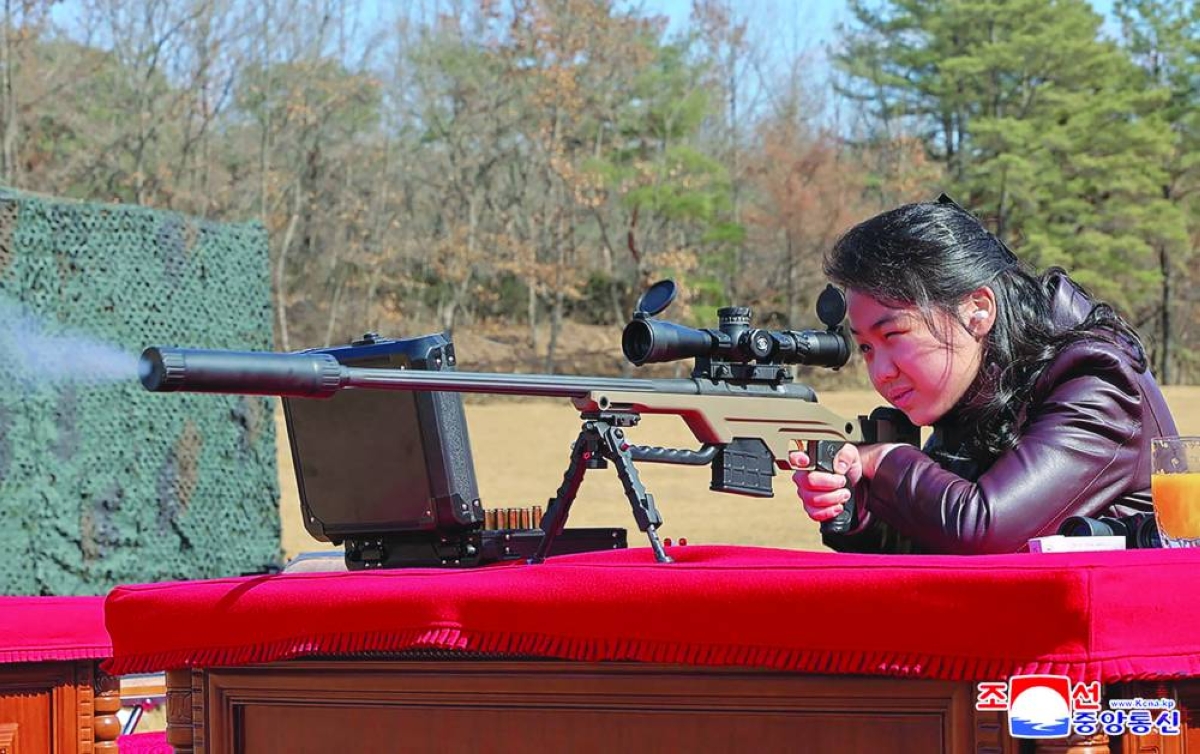 North Korean leader Kim Jong-un's daughter Kim Ju-ae firing a new sniper rifle, at an undisclosed place in North Korea. (AFP)