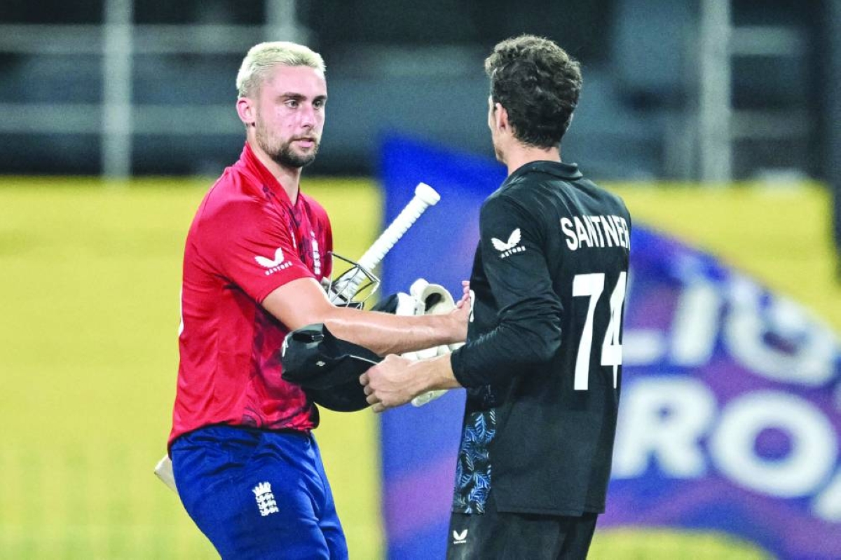 England's Will Jacks (L) is congratulated by New Zealand's captain Mitchell Santner for his team's win at the end of the 2026 ICC Men's T20 Cricket World Cup Super Eights match between England and New Zealand at the R Premadasa Stadium in Colombo on February 27, 2026. (AFP)