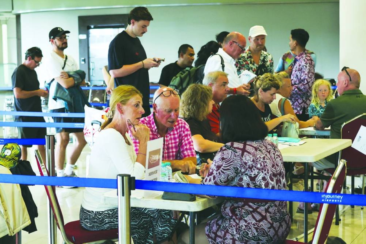 Stranded passengers report to Qatar Airways customer service at I Gusti Ngurah Rai International Airport after flights to Doha, Dubai, and Abu Dhabi were cancelled following strikes on Iran launched by the United States and Israel, in Kuta, Bali, Indonesia, March 1, 2026. REUTERS