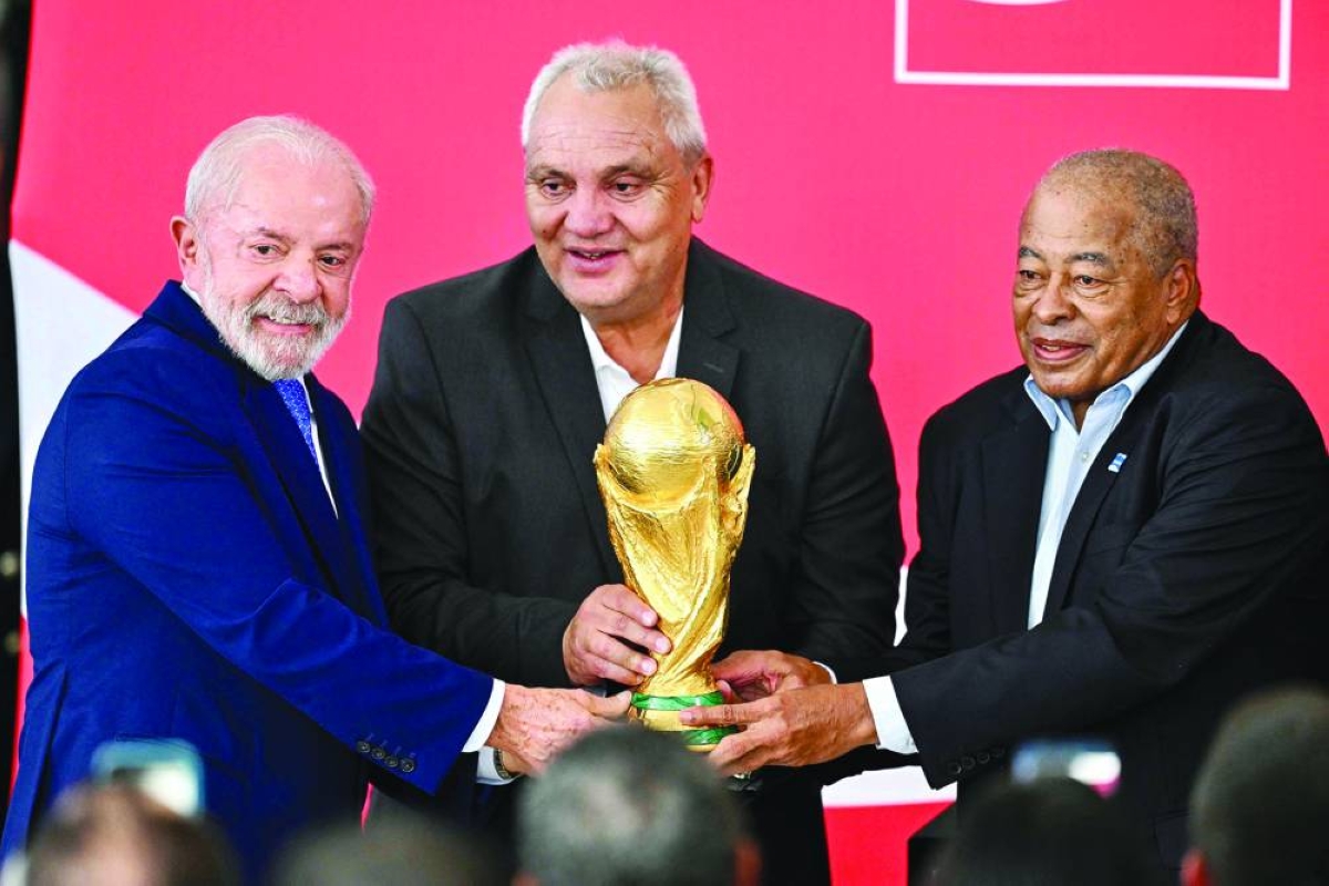 Brazil's President Luiz Inacio Lula da Silva (L) and former Brazilian national team players Branco (C) and Jairzinho (R) hold the World Cup trophy during the FIFA World Cup 2026 Trophy Tour at Planalto Palace in Brasilia, Brazil on February 26, 2026. (AFP)