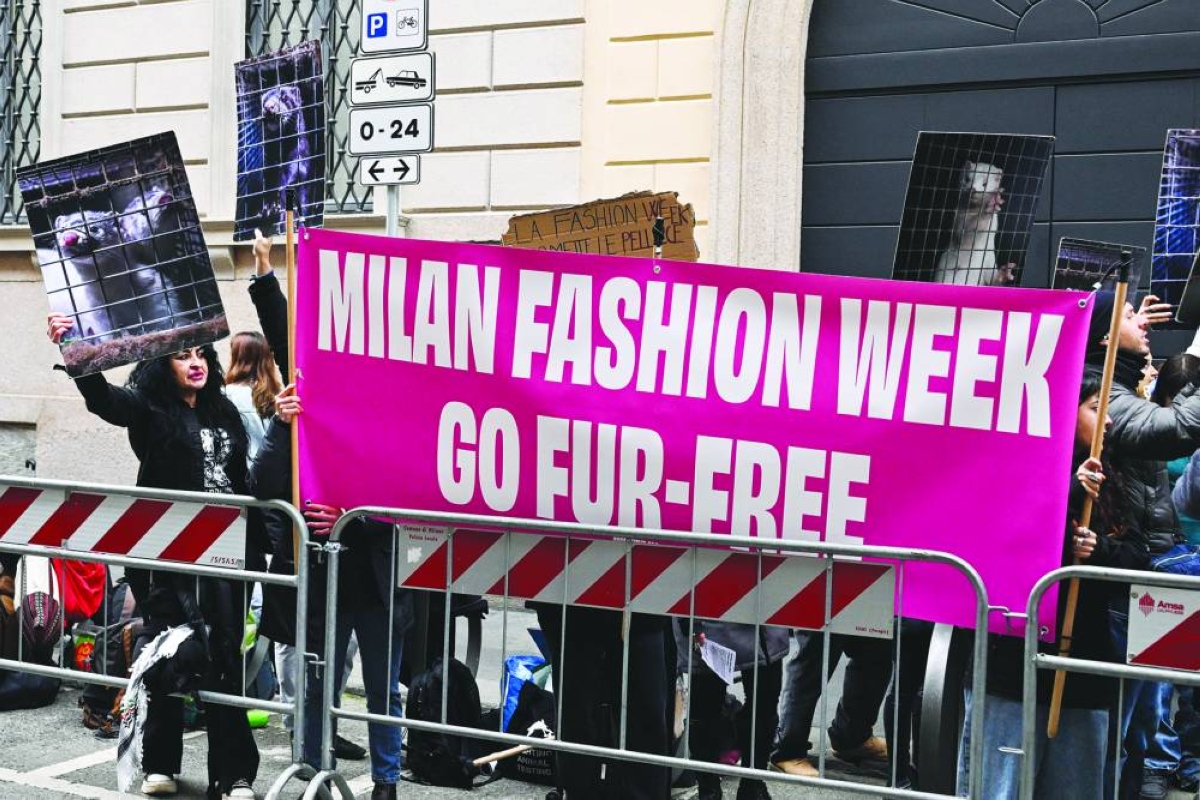 Protesters hold signs reading ‘Ban fur’ ahead of the Giorgio Armani women's ready-to-wear Fall/Winter 2026 collection fashion show as part of the Milan Fashion Week, in Milan Sunday. – AFP