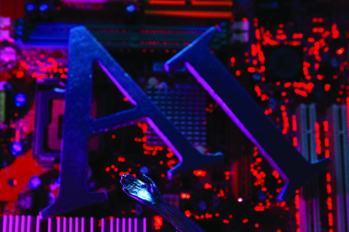 
Artificial Intelligence (AI) letters and robot hand are placed on a computer motherboard in this illustration. (Reuters) 