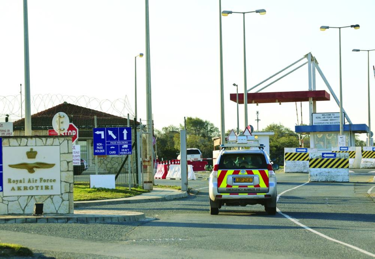 An emergency vehicle passes by the entrance of RAF Akrotiri, a British sovereign base in Cyprus, which was hit by an unmanned drone overnight, causing limited damage, Monday.